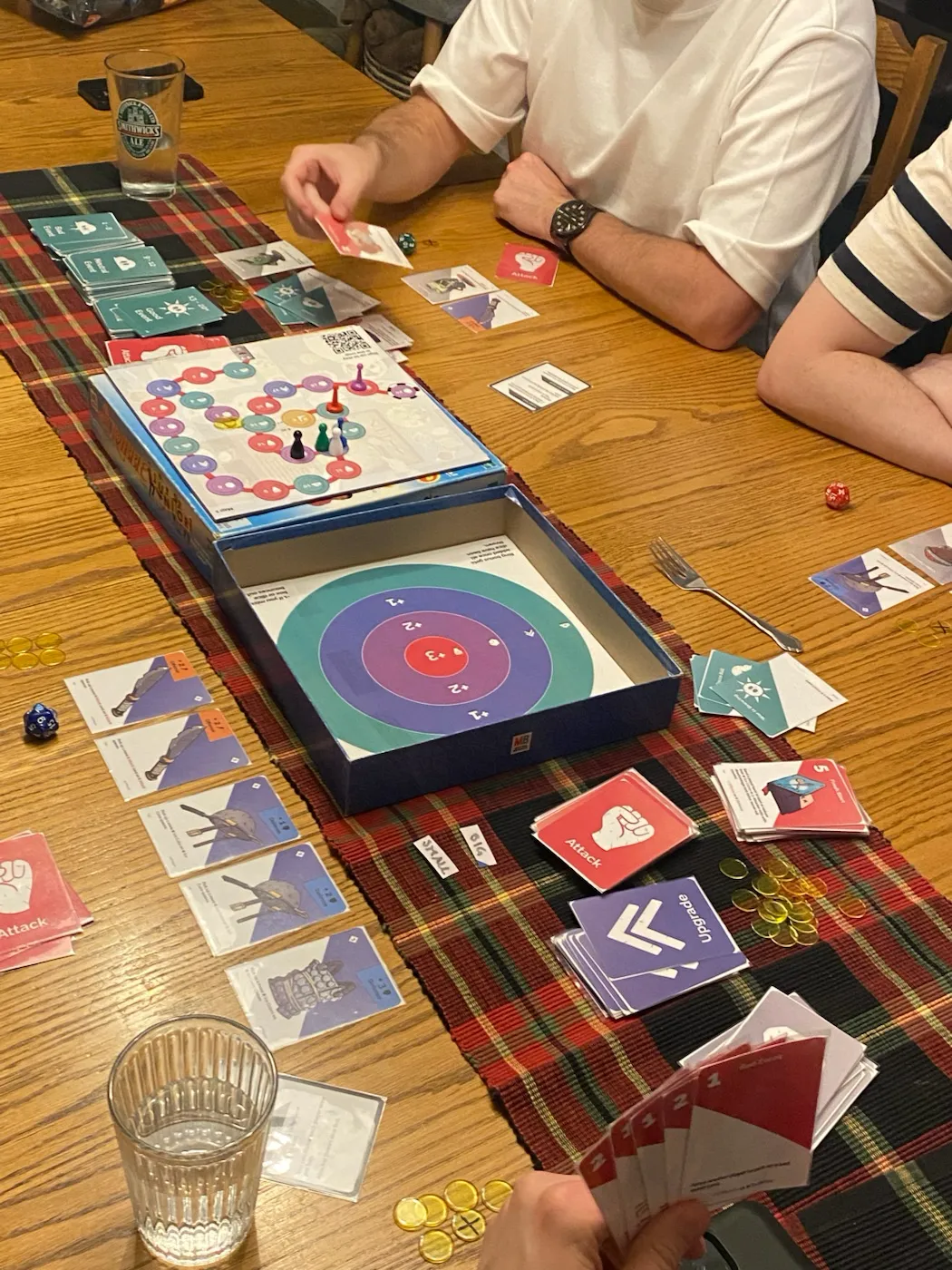 Close-up of Kitchen Kingdom game components including cards and dice