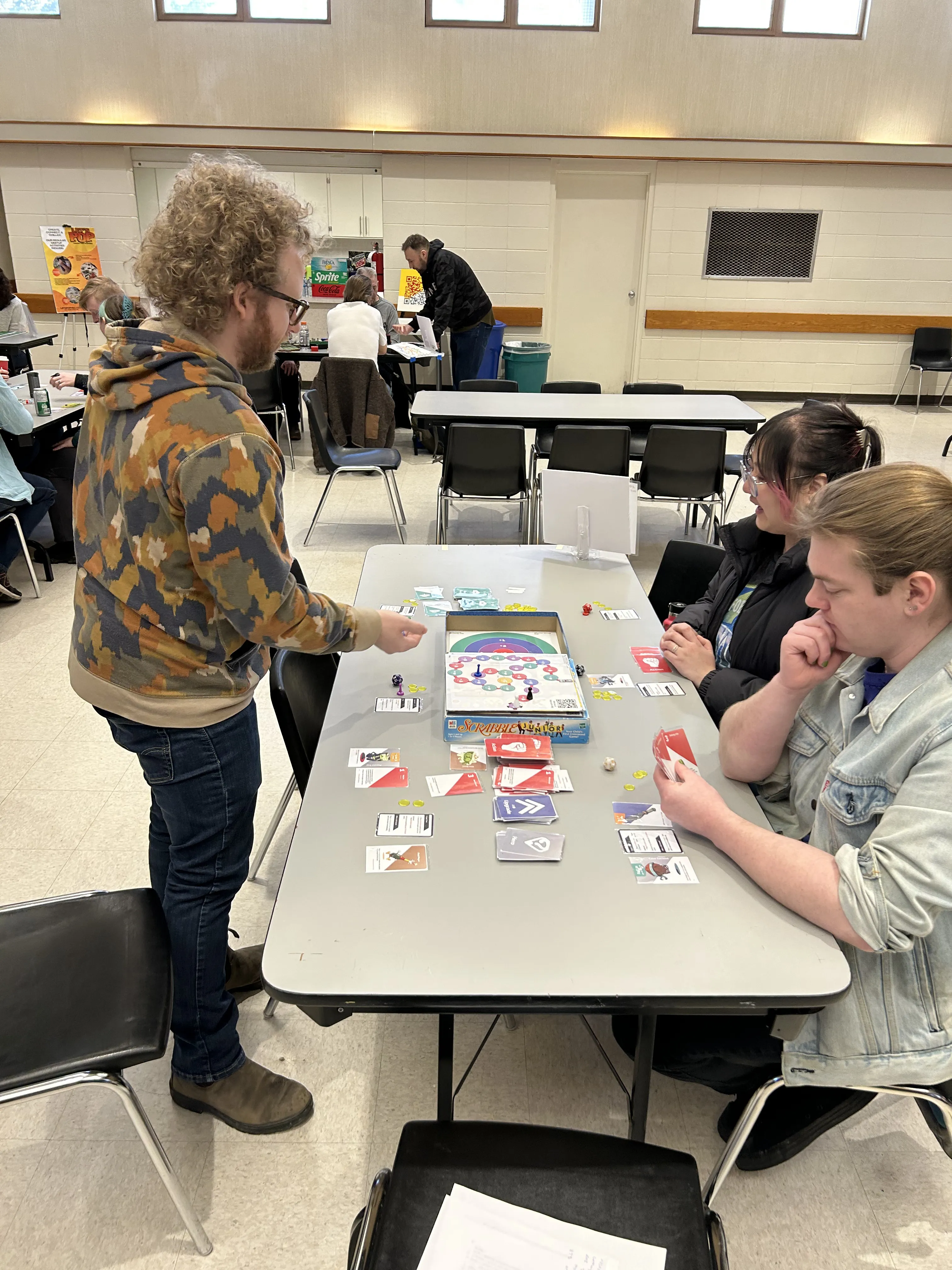 Players gathered around the Kitchen Kingdom game board during a playtest